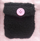 Detail of the black trim and pink button on the PA Pink Herringbone Dog Coat