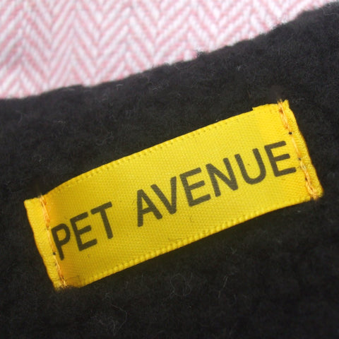 Label on the pink herringbone dog coat indicating it's from Pet Avenue